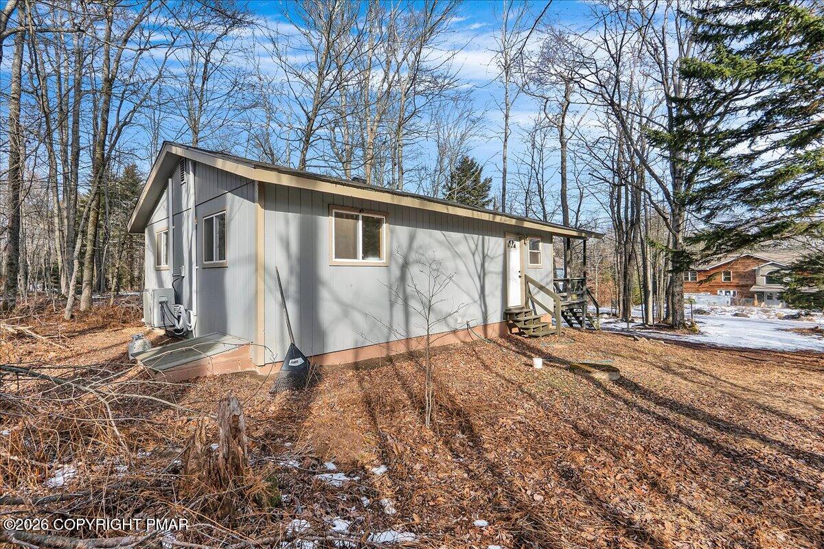 309 Selig Road Pocono Lake, PA 18347 - Photo 22 of 25 a front view of a house with a yard and garage