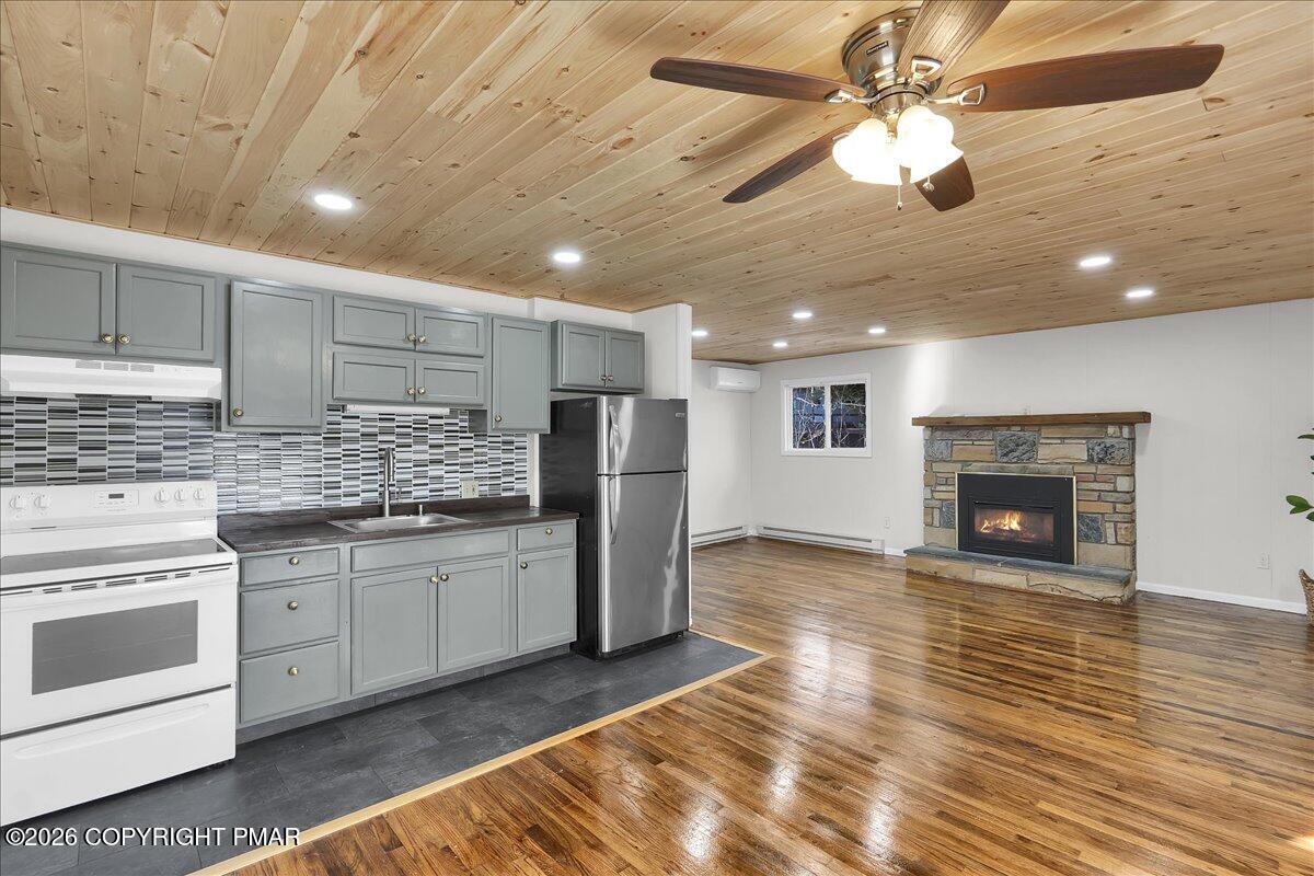 309 Selig Road Pocono Lake, PA 18347 - Photo 4 of 25 a kitchen with stainless steel appliances granite countertop a stove cabinets and wooden floor