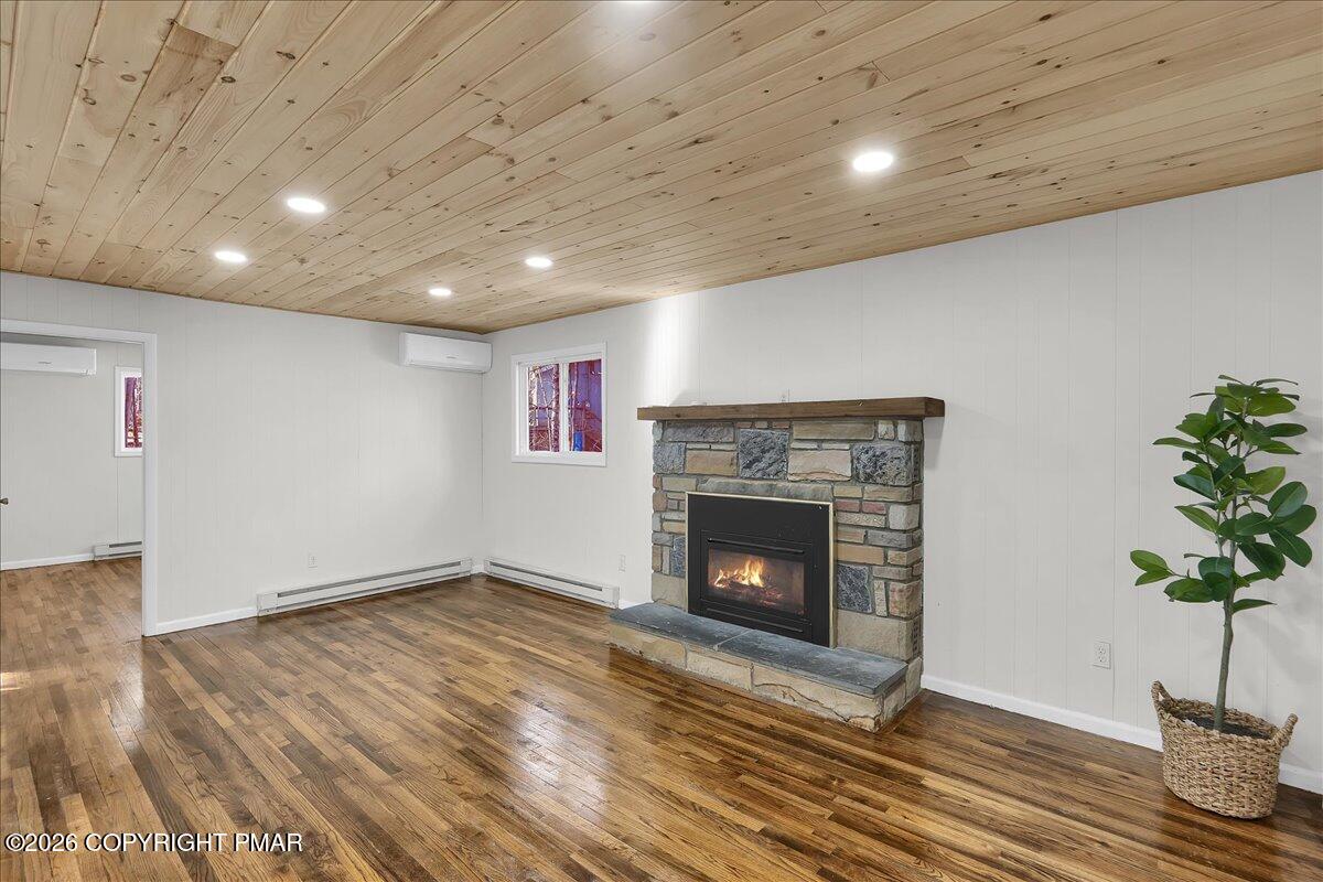 309 Selig Road Pocono Lake, PA 18347 - Photo 6 of 25 a view of an empty room with wooden floor and a fireplace