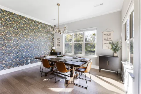 a view of a livingroom with furniture window and wooden floor