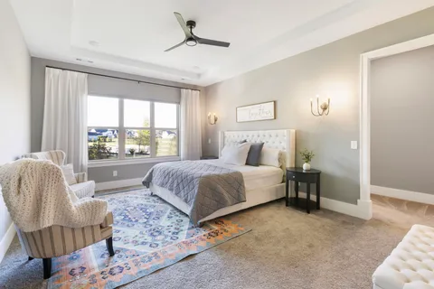 a bedroom with a bed lamp and window