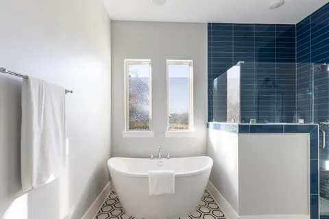 a bathroom with a sink a toilet a mirror and shower curtain