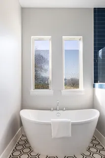 a bedroom with a bed and a chair