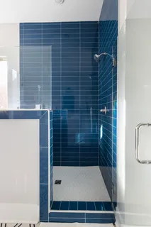 a view of a house with brick walls and a yard with plants