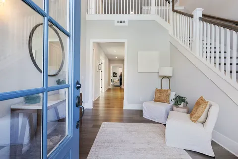 a kitchen with stainless steel appliances kitchen island granite countertop a table chairs sink and cabinets