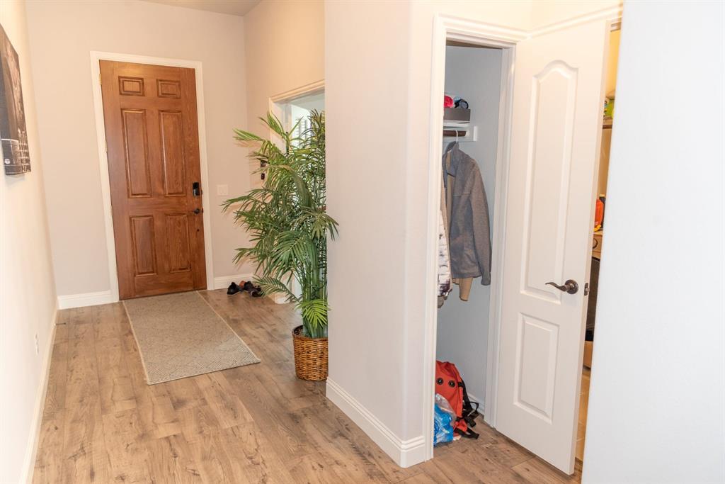 809 Woodview Court Anna, TX 75409 - Photo 12 of 25 a view of a bedroom with wooden floor and closet
