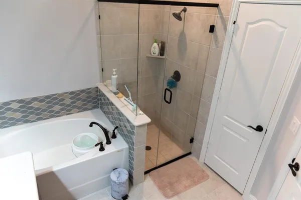a bathroom with a tub and a sink
