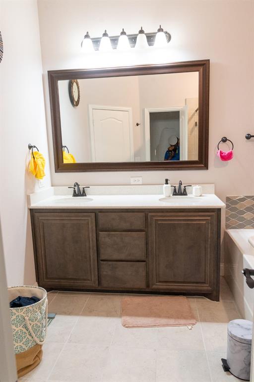 809 Woodview Court Anna, TX 75409 - Photo 15 of 25 a bathroom with a sink vanity and a mirror