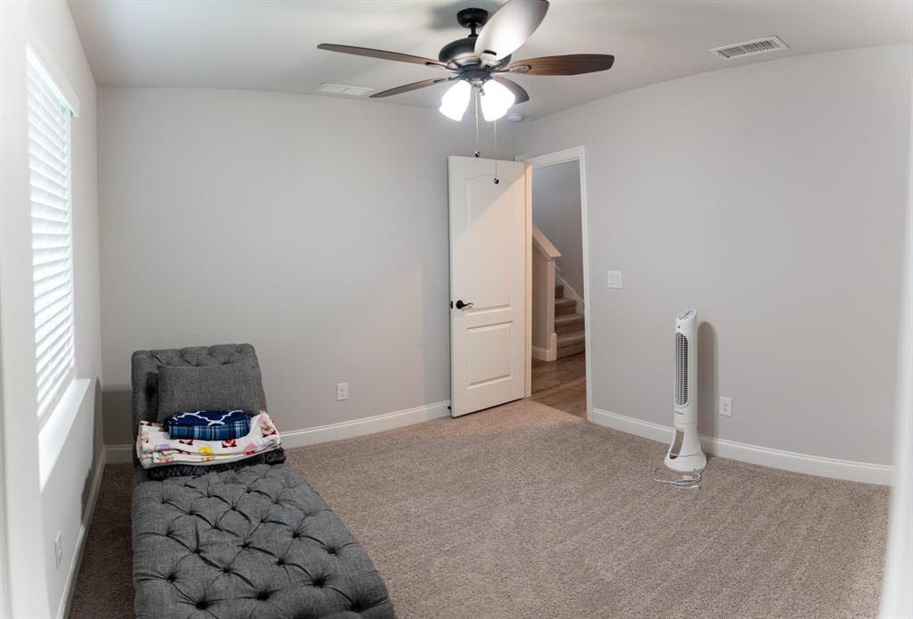 809 Woodview Court Anna, TX 75409 - Photo 24 of 25 a view of a livingroom with cabinet and a ceiling fan