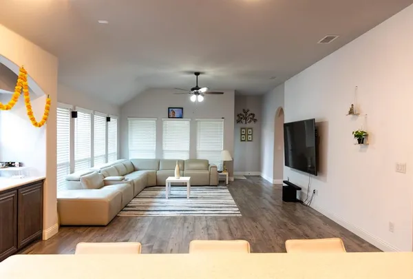 a living room with furniture and a flat screen tv