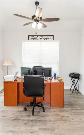 a workspace room with furniture and wooden floor