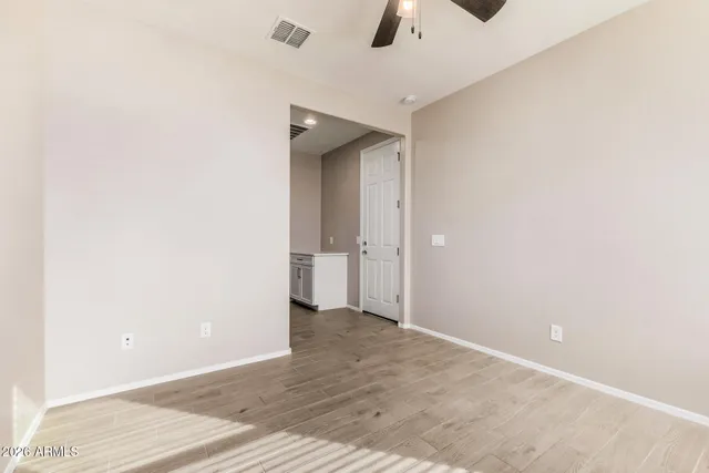 a view of an empty room with a ceiling fan