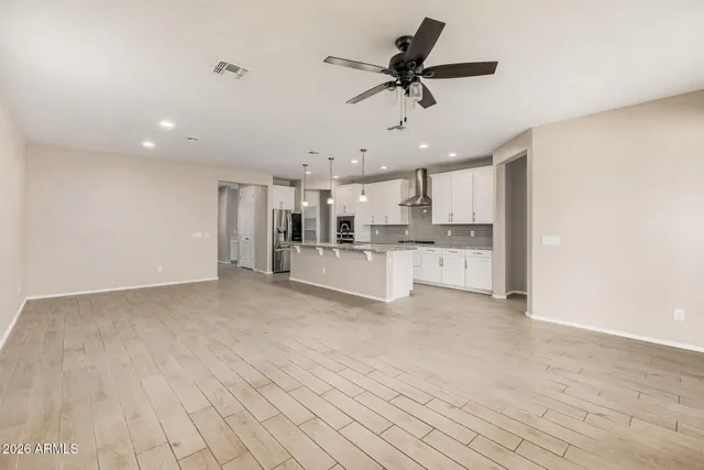 a view of kitchen with stainless steel appliances refrigerator oven and cabinets
