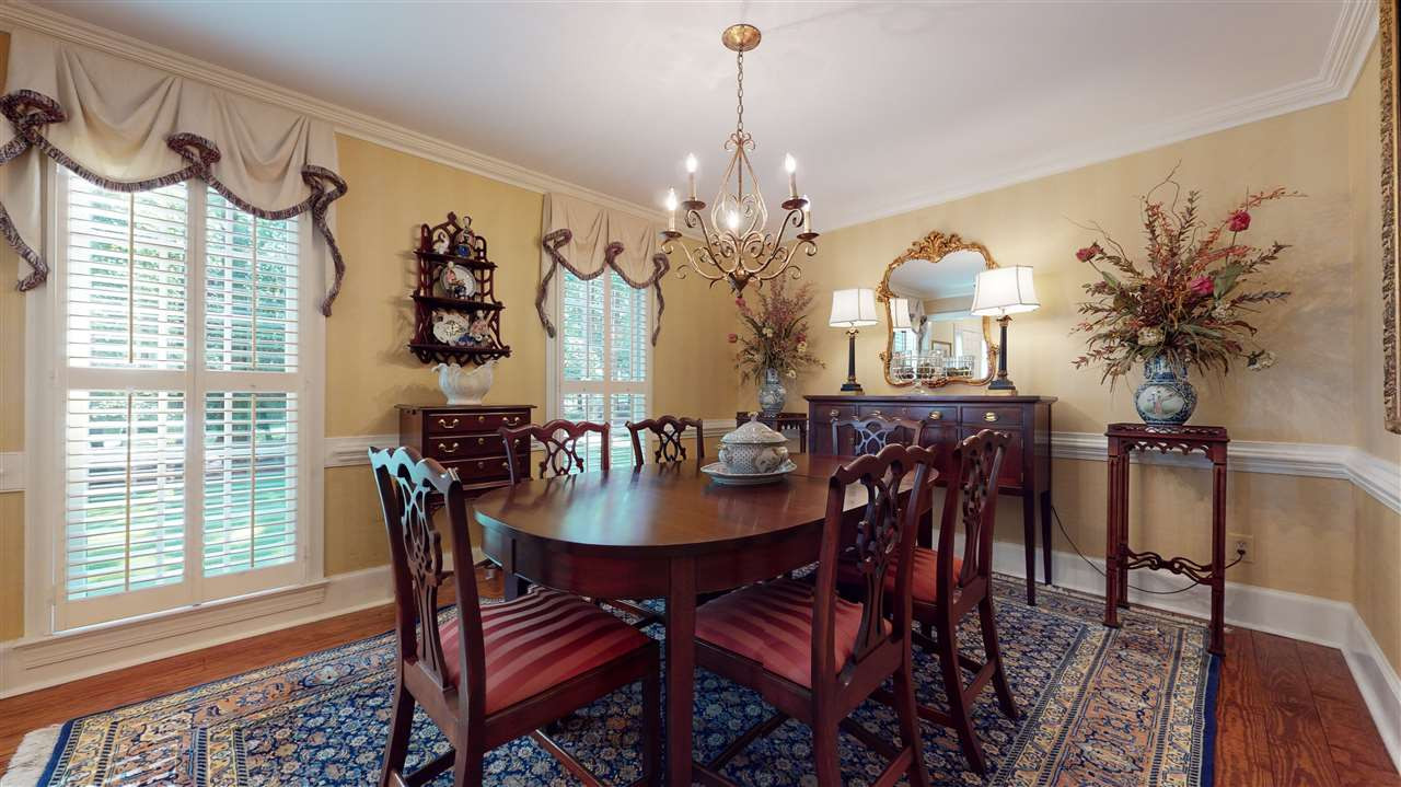 8817 Lomas Court Raleigh, NC 27615 - Photo 11 of 30 Formal dining room with hardwood floors, chair rail and crown molding. Dining Room