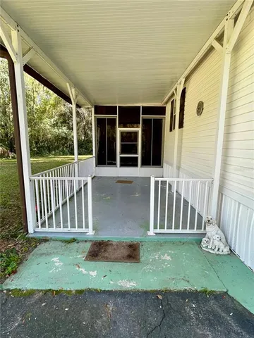a front view of a house with backyard and porch