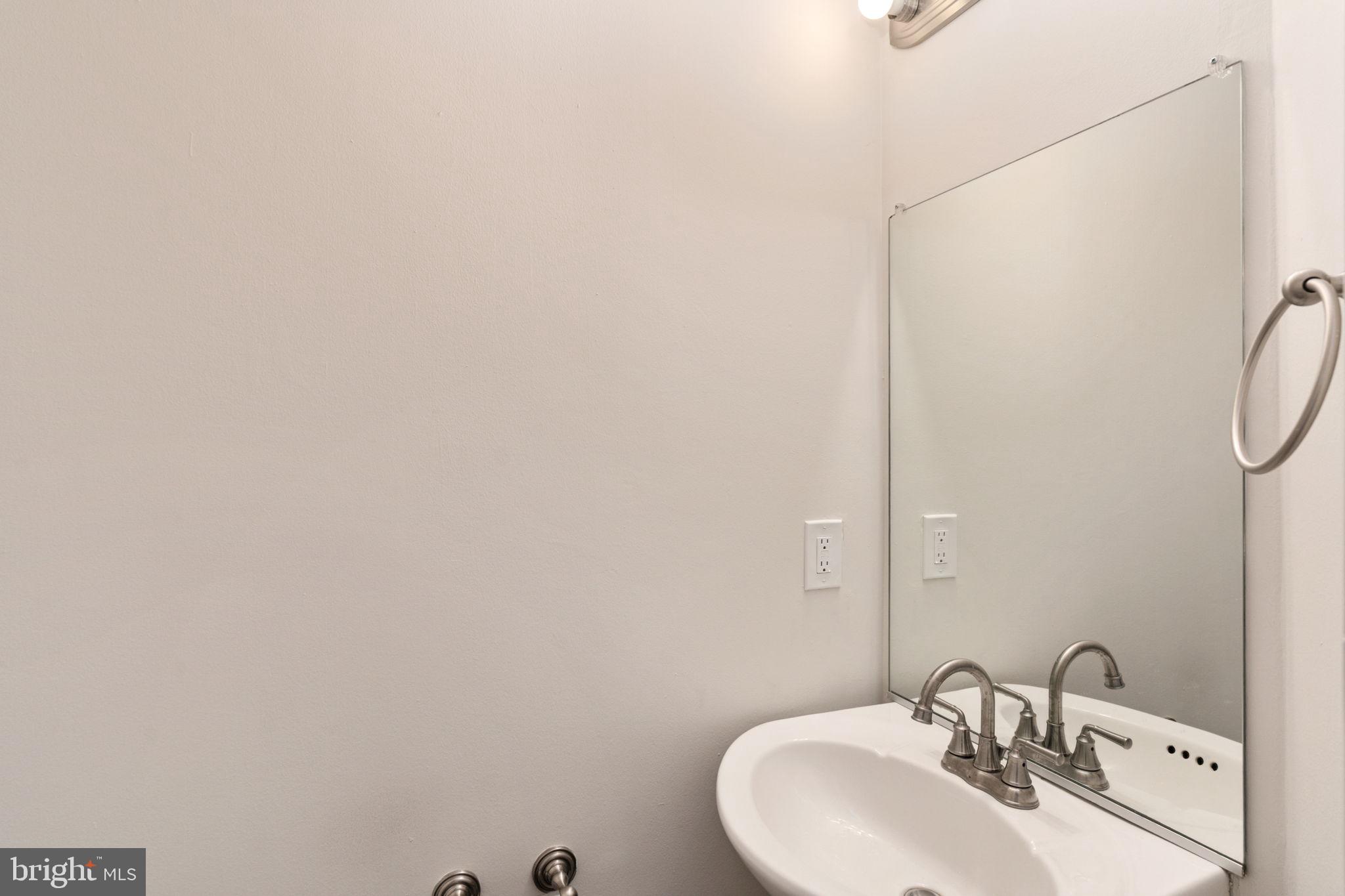 8548 Towne Manor Court Alexandria, VA 22309 - Photo 11 of 53 a bathroom with a sink and mirror
