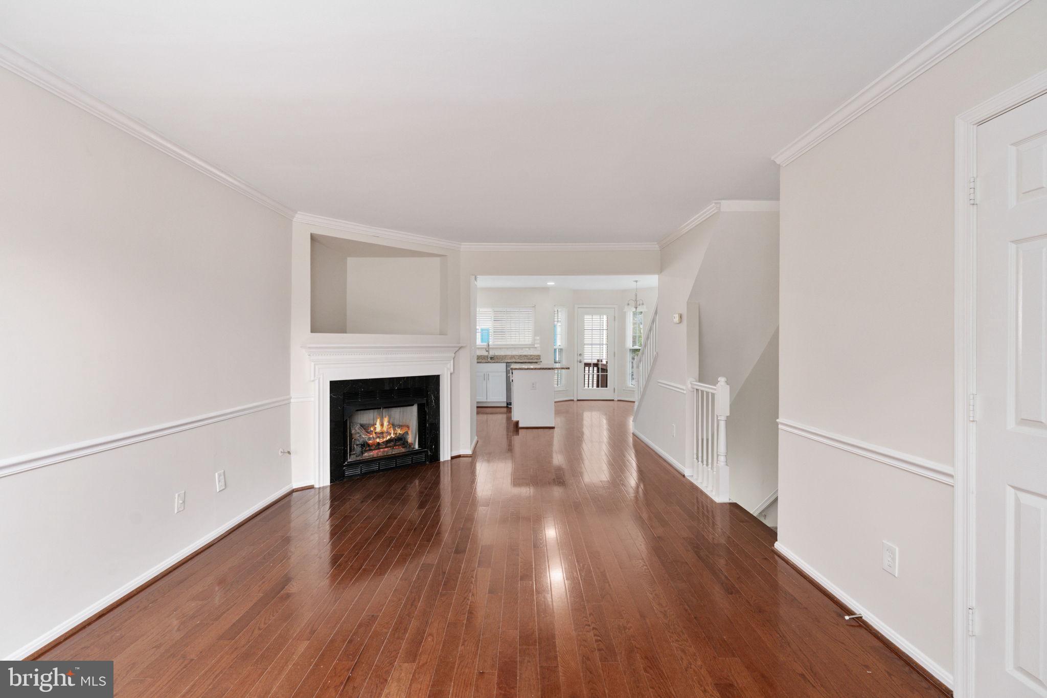 8548 Towne Manor Court Alexandria, VA 22309 - Photo 12 of 53 a view of a livingroom with wooden floor and a fireplace