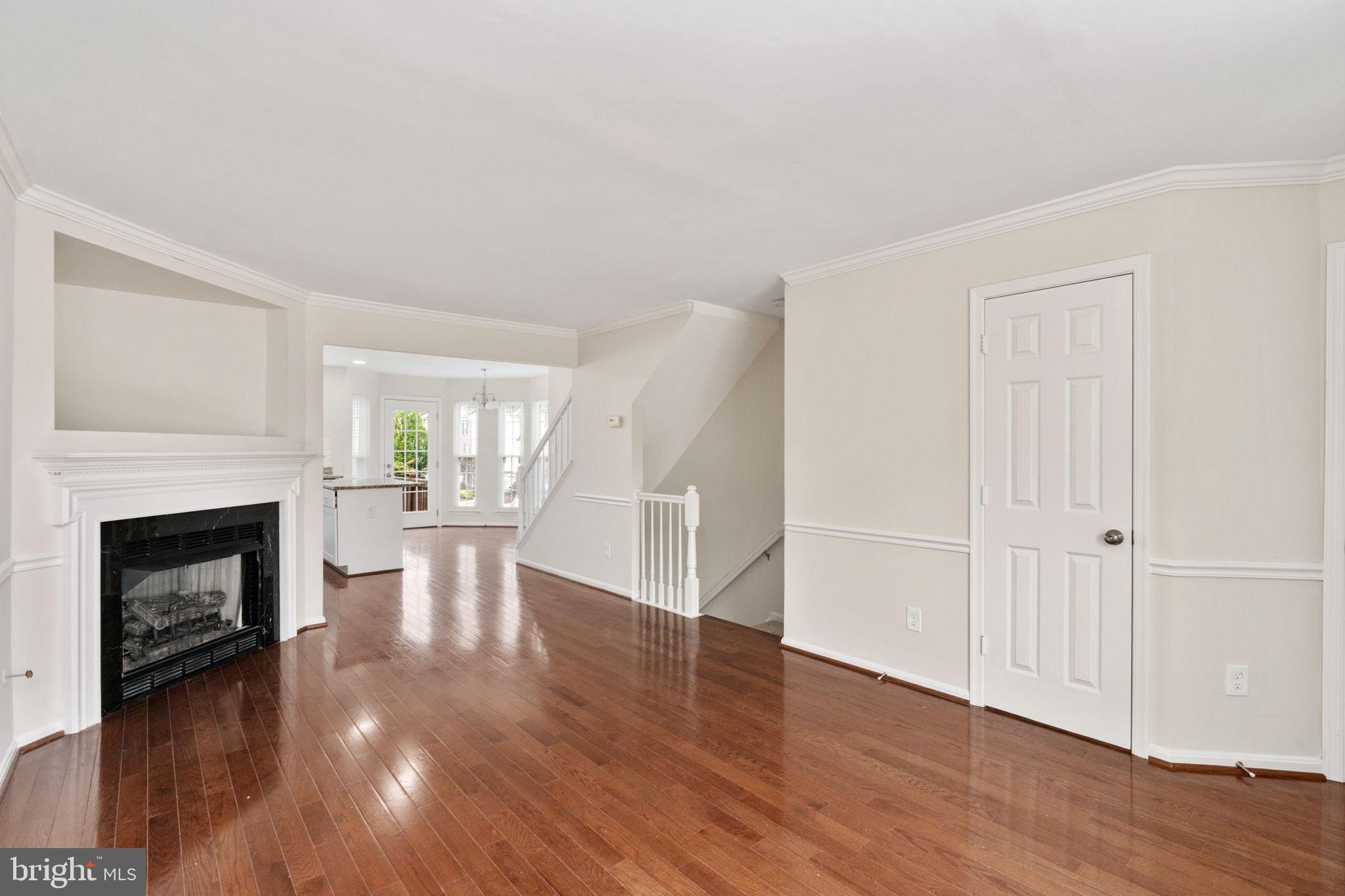 8548 Towne Manor Court Alexandria, VA 22309 - Photo 13 of 53 a view of a livingroom with wooden floor and a fireplace