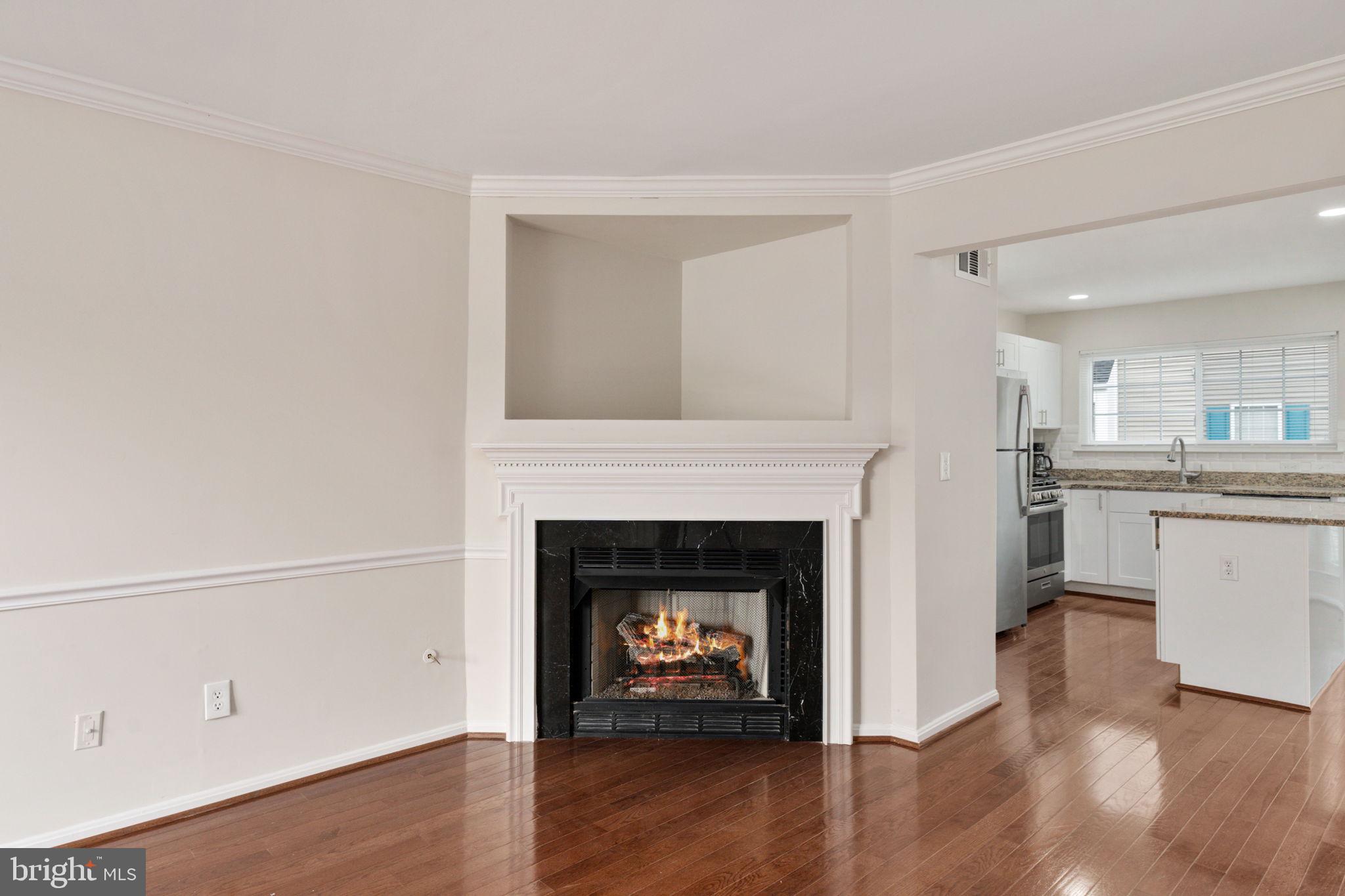 8548 Towne Manor Court Alexandria, VA 22309 - Photo 14 of 53 a room with a fireplace and wooden floor