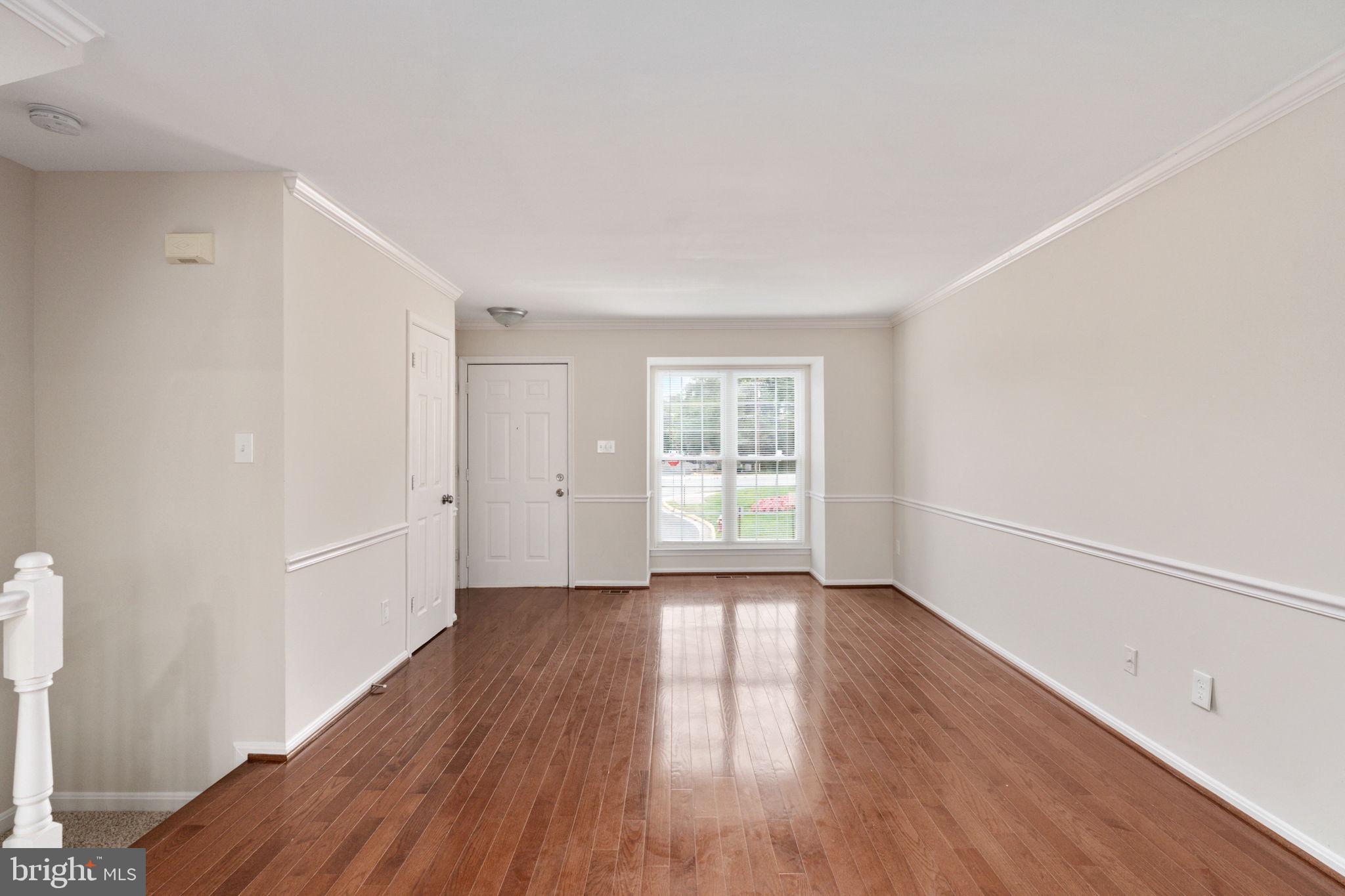 8548 Towne Manor Court Alexandria, VA 22309 - Photo 15 of 53 an empty room with wooden floor and windows