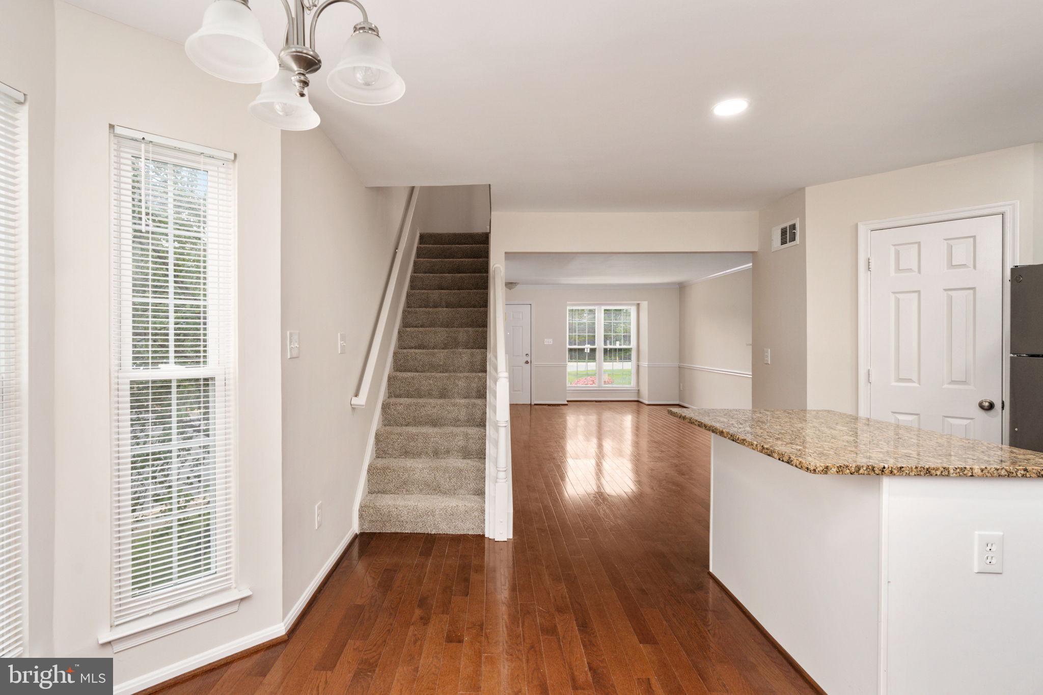 8548 Towne Manor Court Alexandria, VA 22309 - Photo 18 of 53 a view of a livingroom with wooden floor and staircase