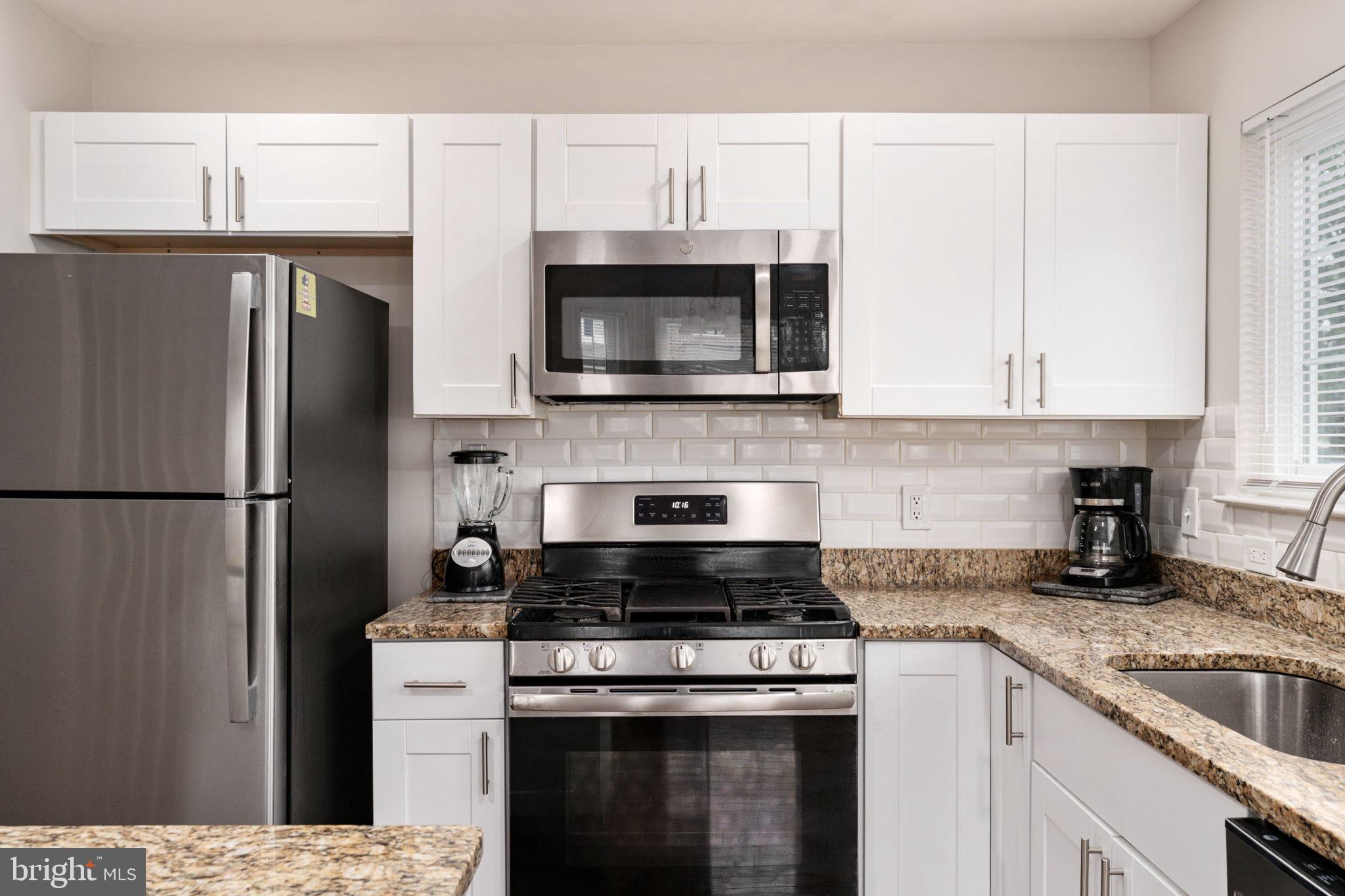 8548 Towne Manor Court Alexandria, VA 22309 - Photo 21 of 53 a kitchen with cabinets stainless steel appliances and a sink