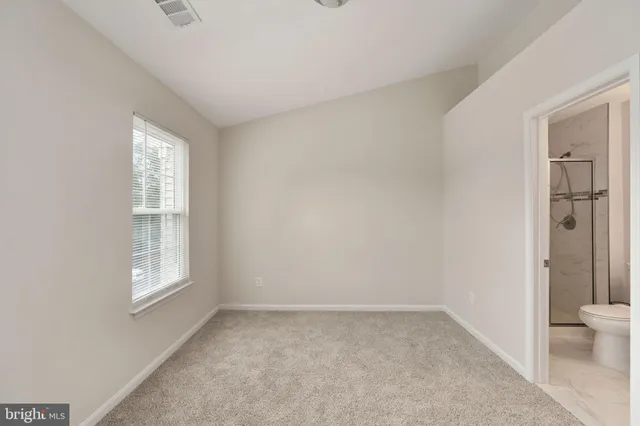 a view of an empty room and closet area