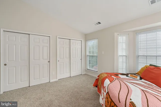 a bedroom with a bed and a lamp