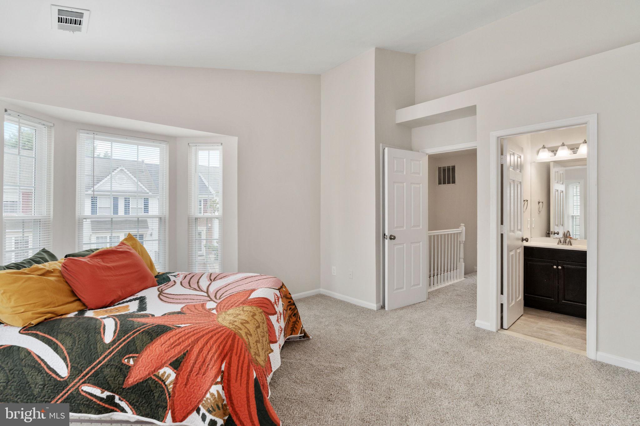 8548 Towne Manor Court Alexandria, VA 22309 - Photo 35 of 53 a bedroom with a bed and a lamp