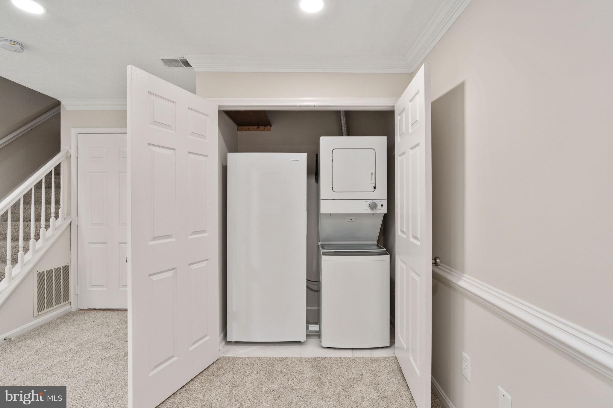 8548 Towne Manor Court Alexandria, VA 22309 - Photo 43 of 53 a view of a kitchen with refrigerator and white cabinets