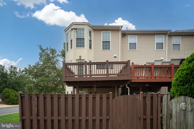 a view of a house with wooden fence