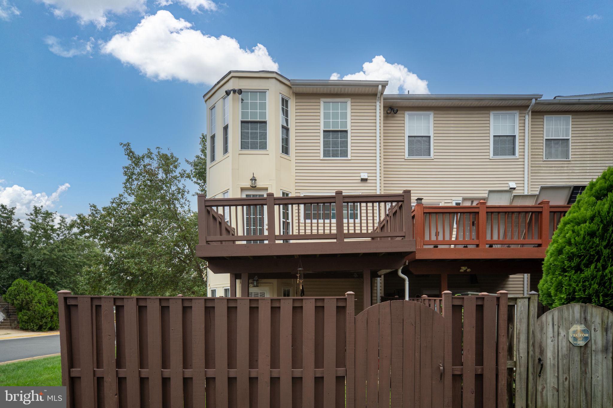 8548 Towne Manor Court Alexandria, VA 22309 - Photo 45 of 53 a view of a house with wooden deck and furniture