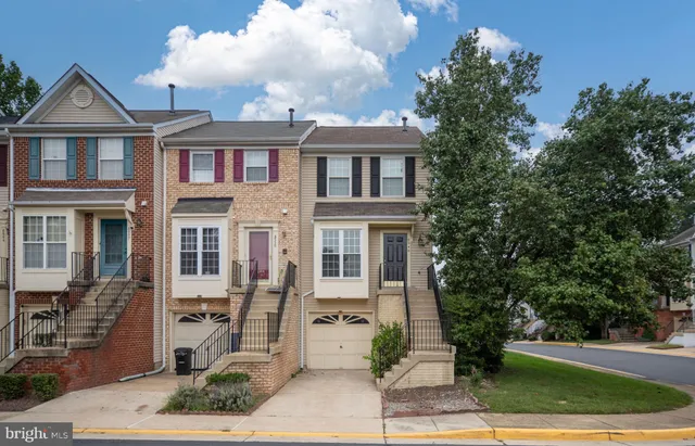 a front view of a residential apartment building with a yard
