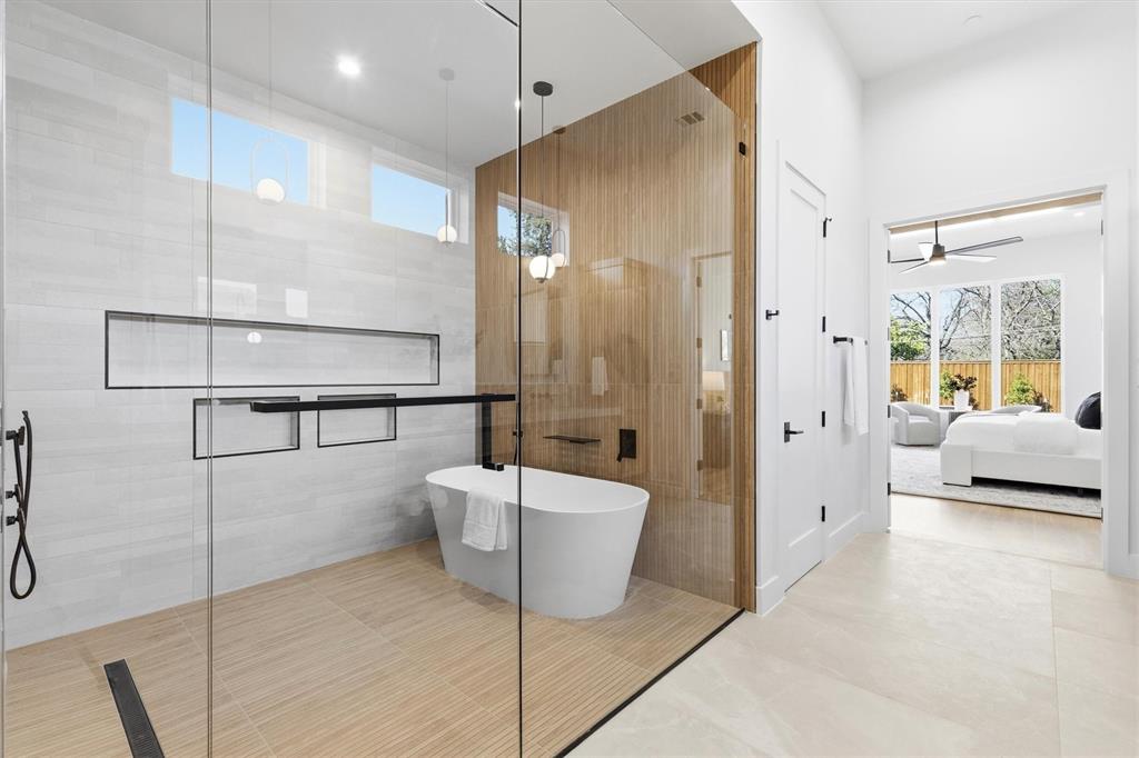 6257 Turner Way Dallas, TX 75230 - Photo 19 of 39 a bathroom with a bathtub and a shower