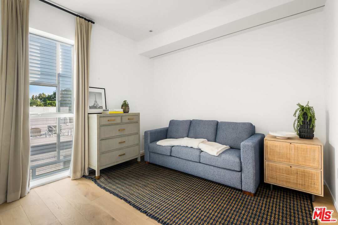 1030 North Kings Road, Unit 407 West Hollywood, CA 90069 - Photo 11 of 19 a living room with furniture and a dresser