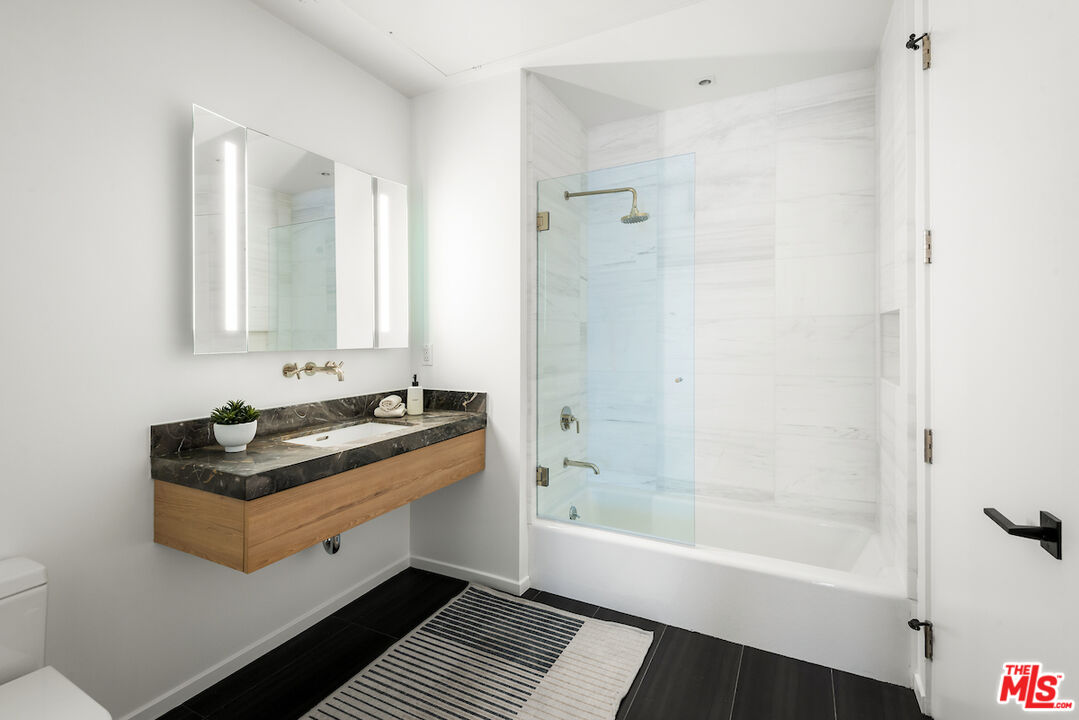 1030 North Kings Road, Unit 407 West Hollywood, CA 90069 - Photo 12 of 19 a bath room with a bath tub and a shower
