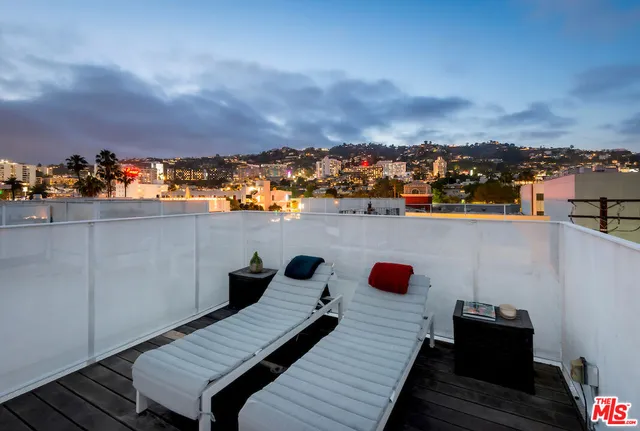 a view of city from terrace with seating area
