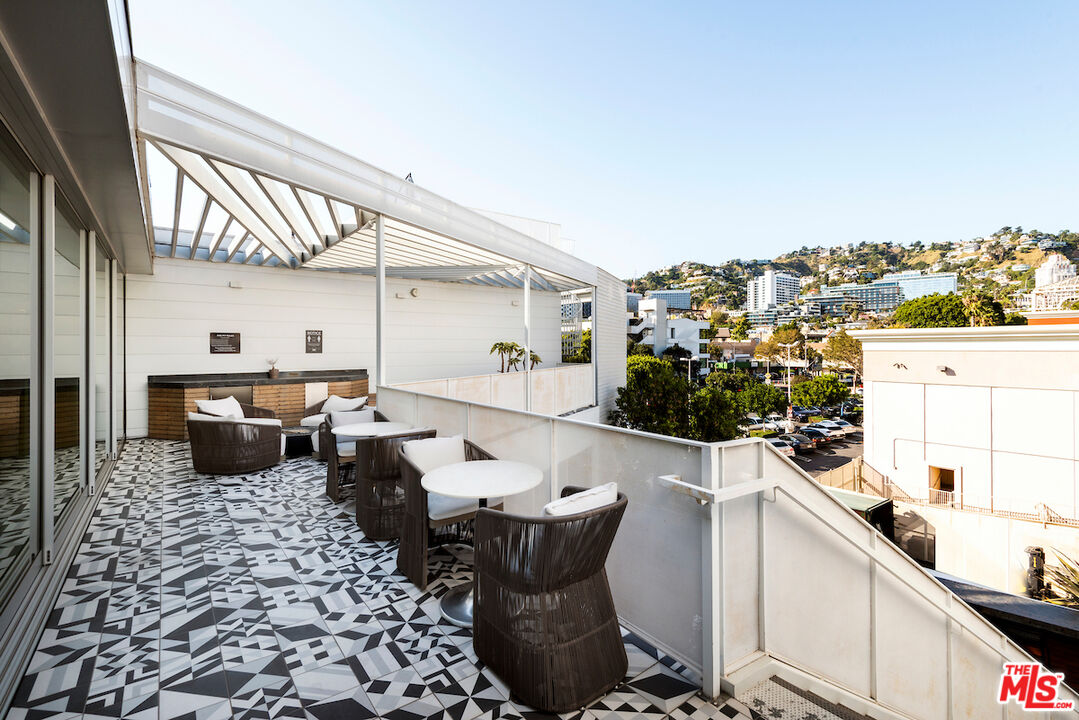 1030 North Kings Road, Unit 407 West Hollywood, CA 90069 - Photo 16 of 19 a kitchen with a sink and a stove top oven