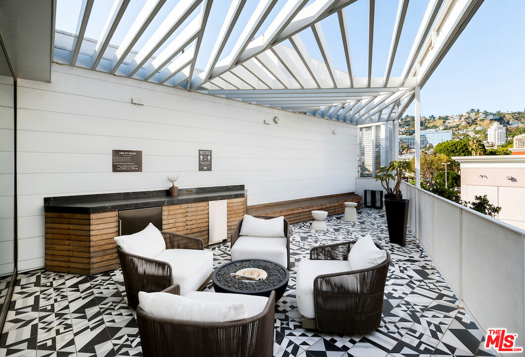 1030 North Kings Road, Unit 407 West Hollywood, CA 90069 - Photo 17 of 19 a dining room with furniture and wooden floor