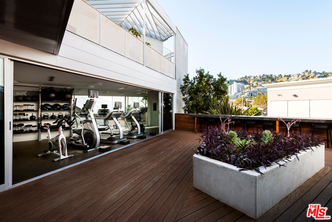 1030 North Kings Road, Unit 407 West Hollywood, CA 90069 - Photo 18 of 19 a living room with a couch and a table