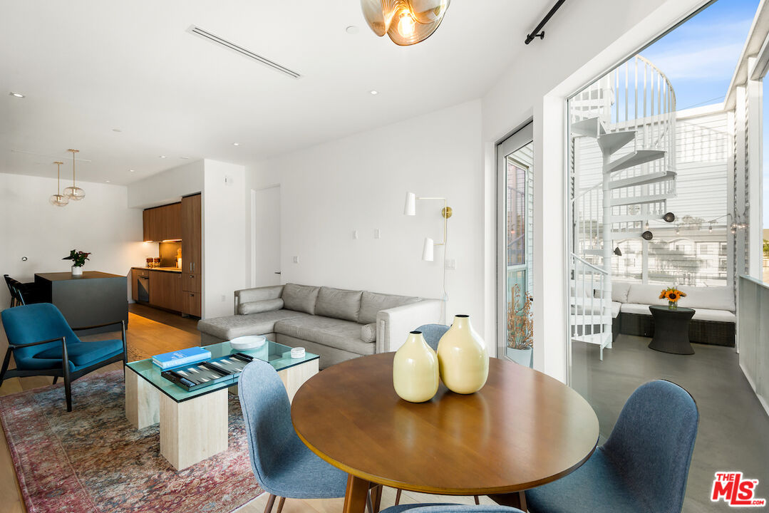 1030 North Kings Road, Unit 407 West Hollywood, CA 90069 - Photo 6 of 19 a living room with furniture and a chandelier
