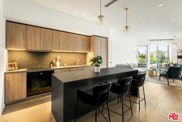 a kitchen with a sink cabinets and wooden floor