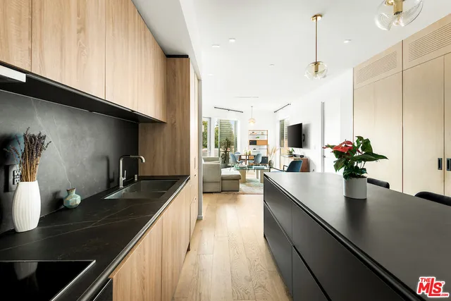a kitchen with counter top space a sink and cabinets