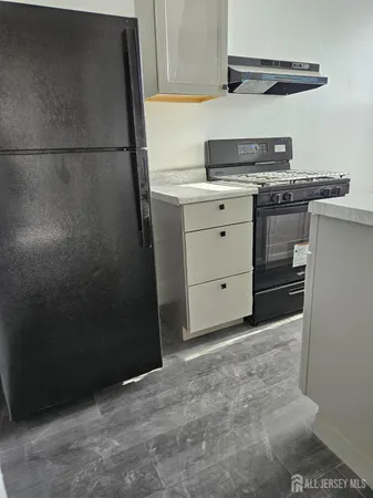 a kitchen with a stove and a refrigerator
