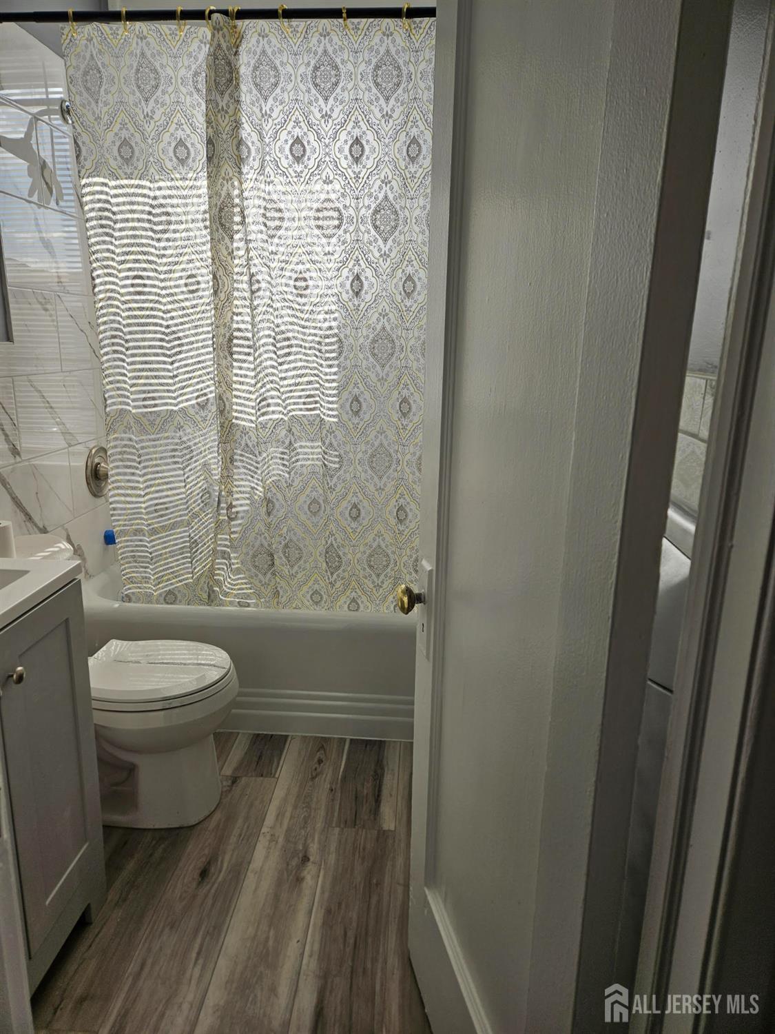 110 Market Street, Unit 3E Perth Amboy, NJ 08861 - Photo 3 of 5 a bathroom with a toilet and a shower