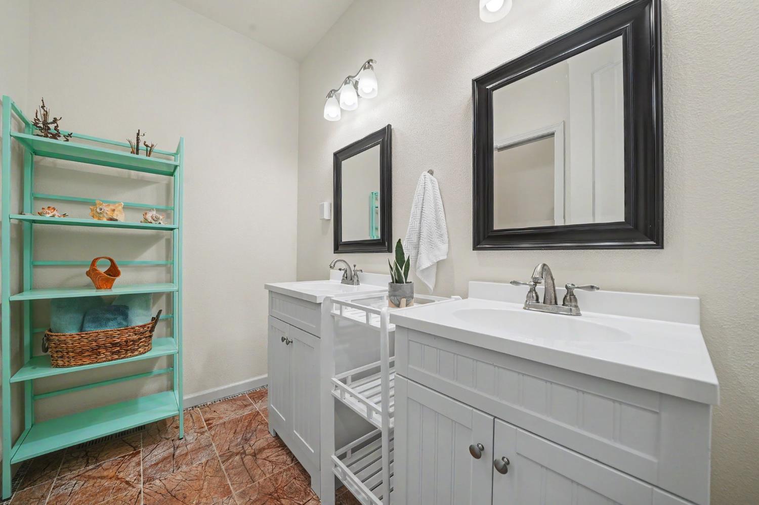 6066 Bluff View Road Copperopolis, CA 95228 - Photo 58 of 96 a bathroom with a sink and a mirror