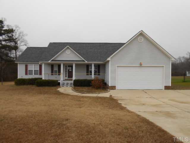 295 Axum Road Willow Spring, NC 27592 - Photo 1 of 8 a front view of a house with yard and garage