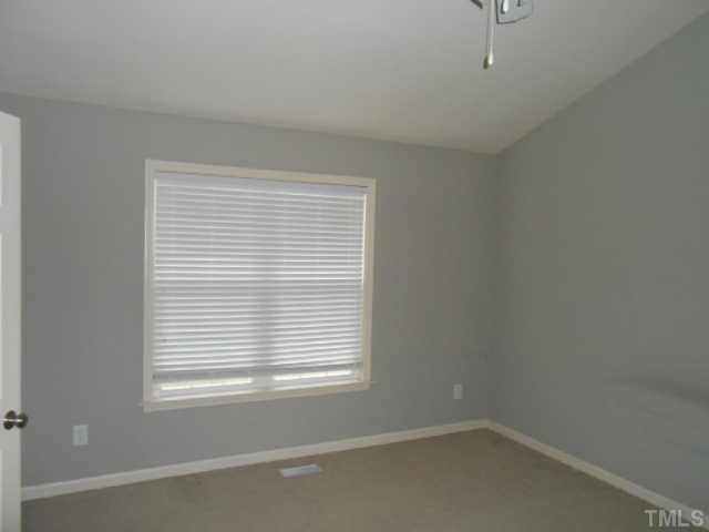 295 Axum Road Willow Spring, NC 27592 - Photo 8 of 8 an empty room with a window