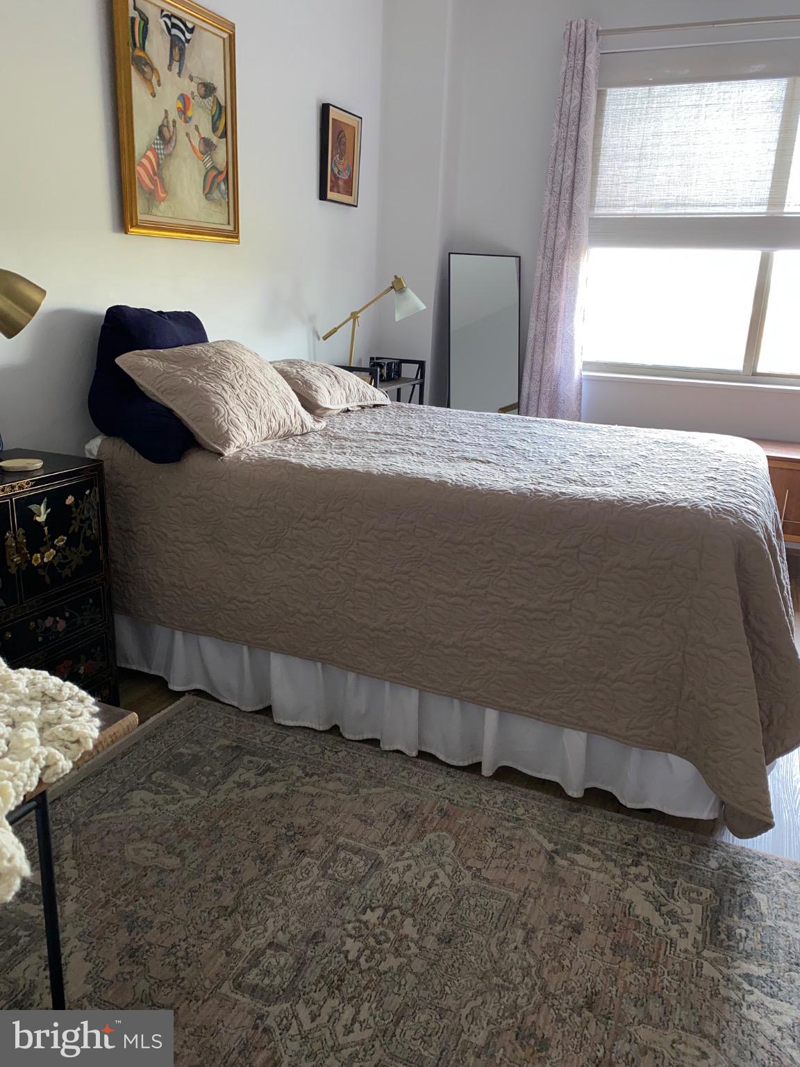 3200 North Leisure World Boulevard, Unit 514 Silver Spring, MD 20906 - Photo 12 of 26 a bedroom with a bed and a painting on the wall