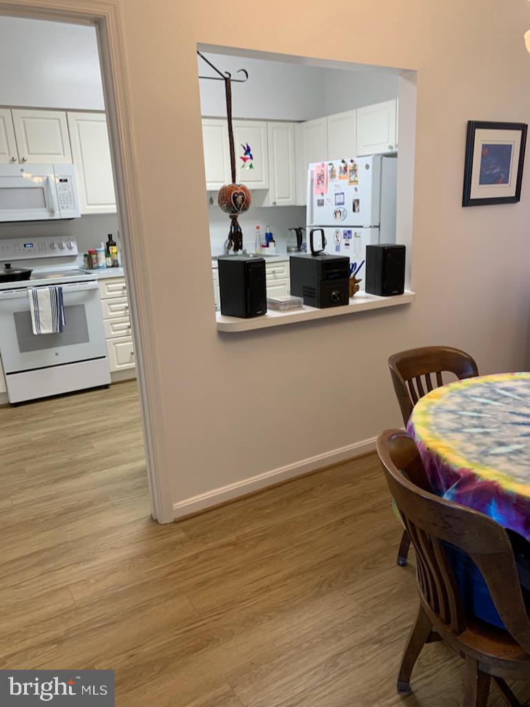 3200 North Leisure World Boulevard, Unit 514 Silver Spring, MD 20906 - Photo 8 of 26 a living room with furniture and a wooden floor